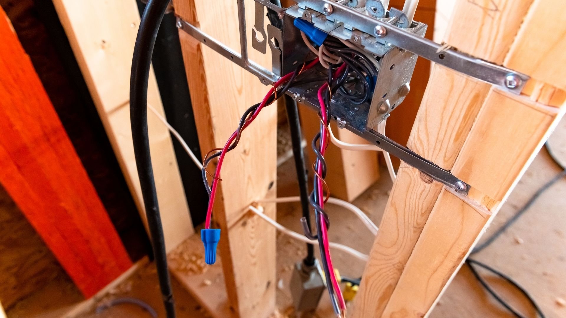 Electrical wiring and junction box installed in wooden wall framing