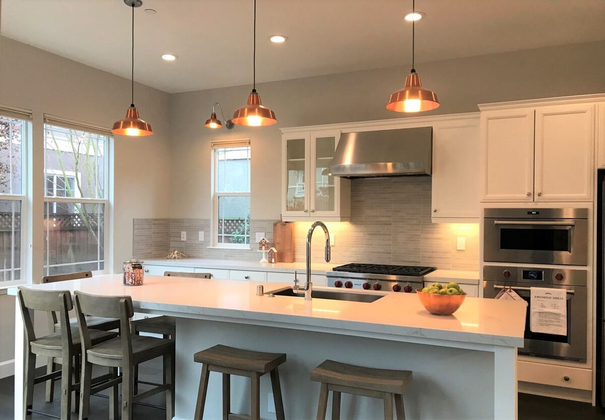 Copper pendant lights over a kitchen island installed by Peak Property Electric