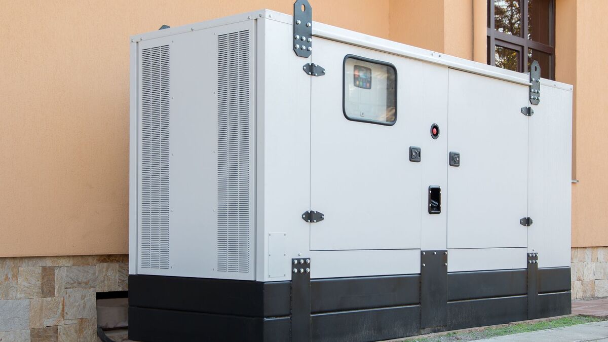 Whole-home standby generator installed beside a house